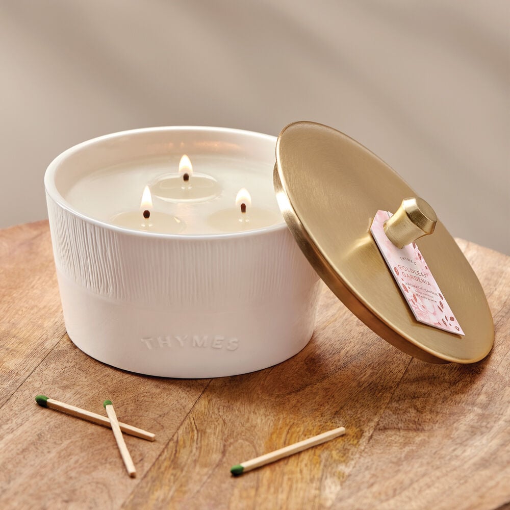 Thymes Goldleaf Gardenia 3-Wick Candle on table image number 1